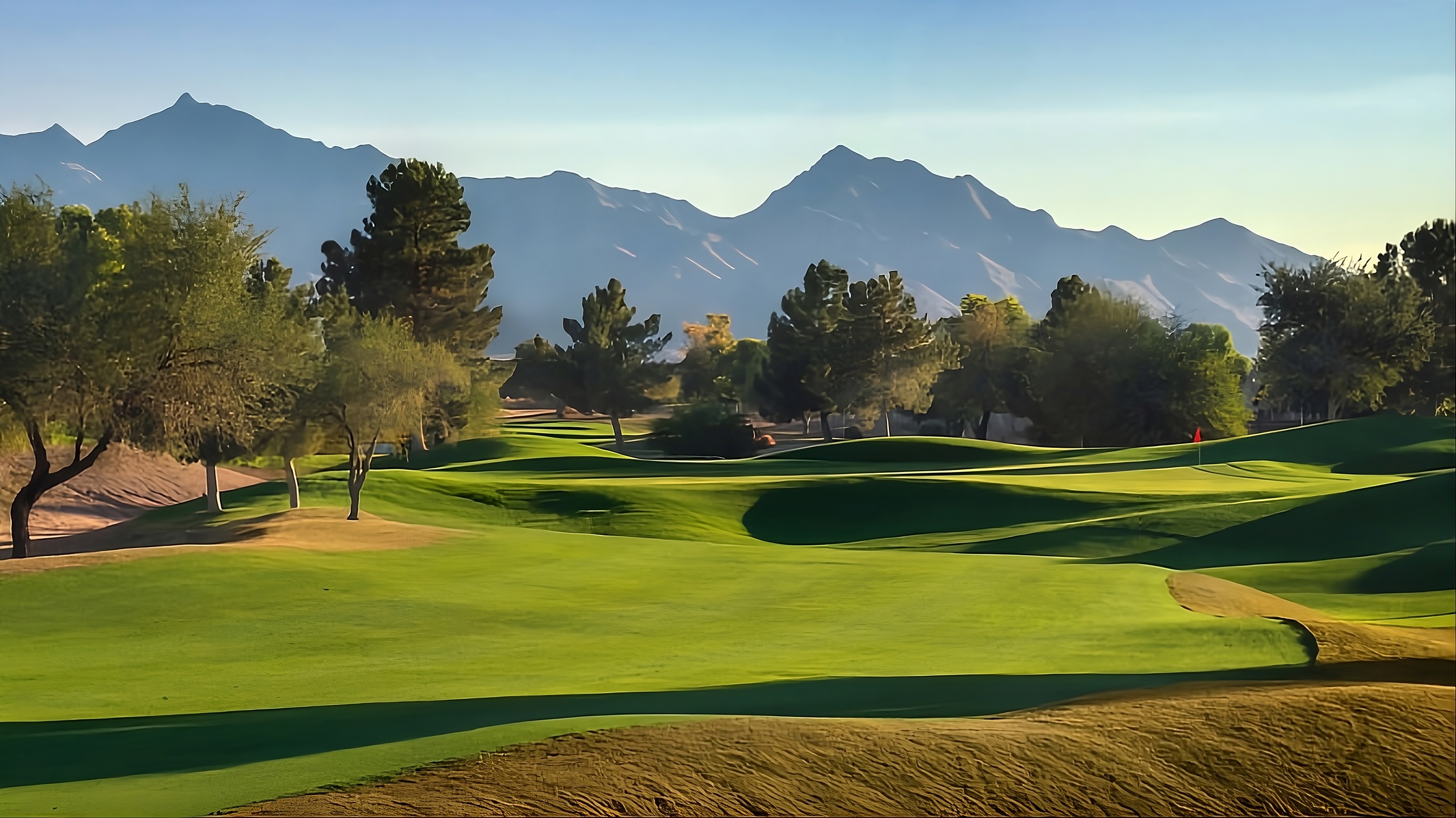 Image of golf ball on tee on grass.